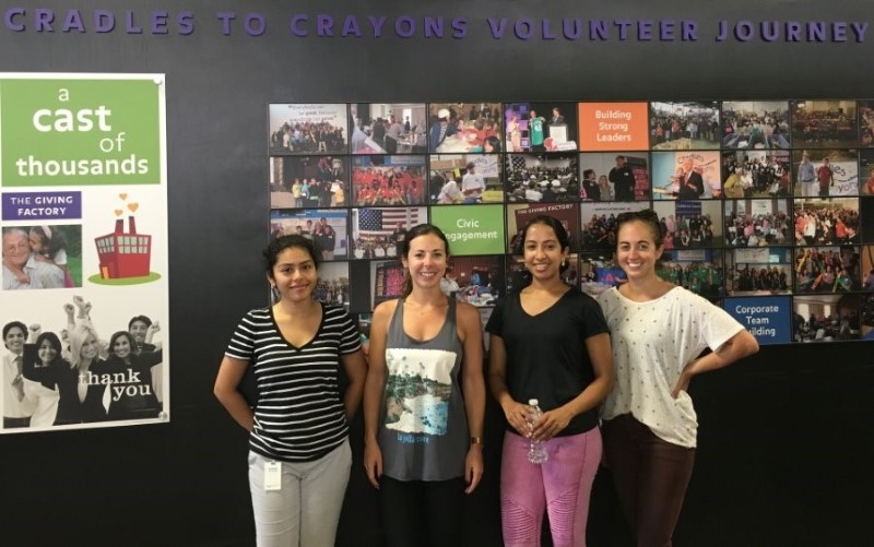 Velir employees Ayushmati Das, Amanda Strout, Divya Mathew, and BreAnn Kopcza pose for a photo together at Cradles to Crayons.