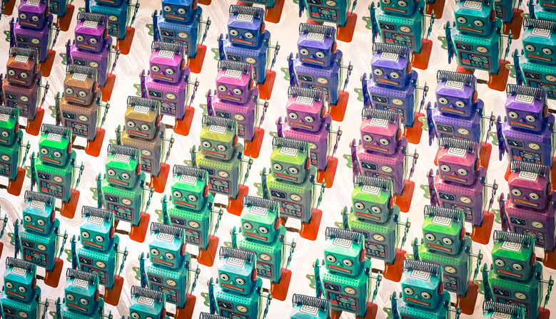 Multi-colored robots that all look the same marching in lines.